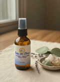 Calm the Storm Daily Intention Spray, 2 oz, on a textured surface with a bowl of stones and leaves