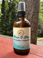 Focus + Flow Daily Intention Spray, 4 oz, on a wooden surface outdoors
