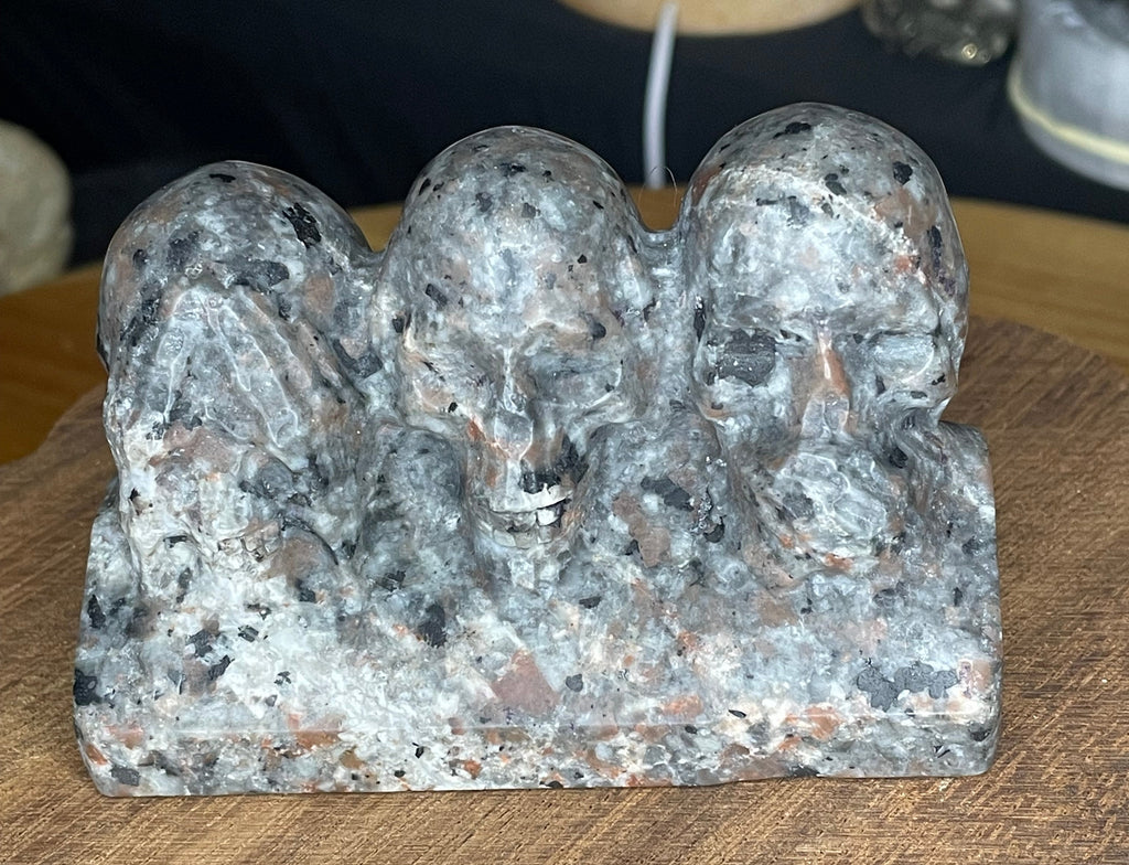 Speckled gray and black Yooperlite See No Evil, Hear No Evil, Speak No Evil Carving - 402 g by Sirius and the Wren, featuring three skulls depicting the classic motif.