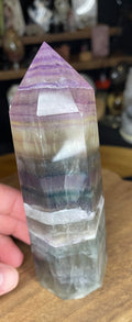 Chunky Rainbow Fluorite Tower - UV Reactive - 428 g featuring polished horizontal bands of purple, yellow, and green.