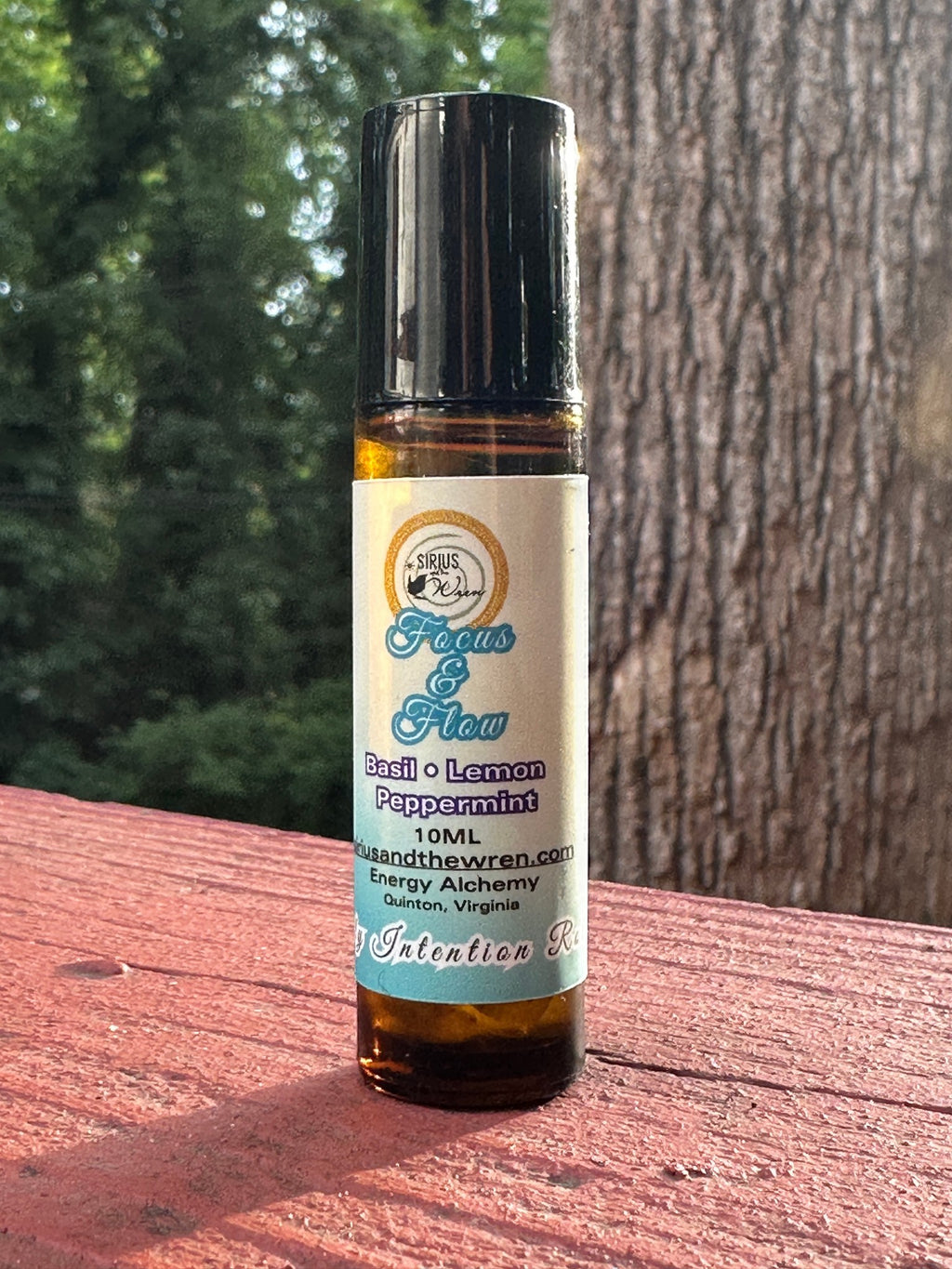 Focus + Flow Intention Roller on a wooden surface outdoors