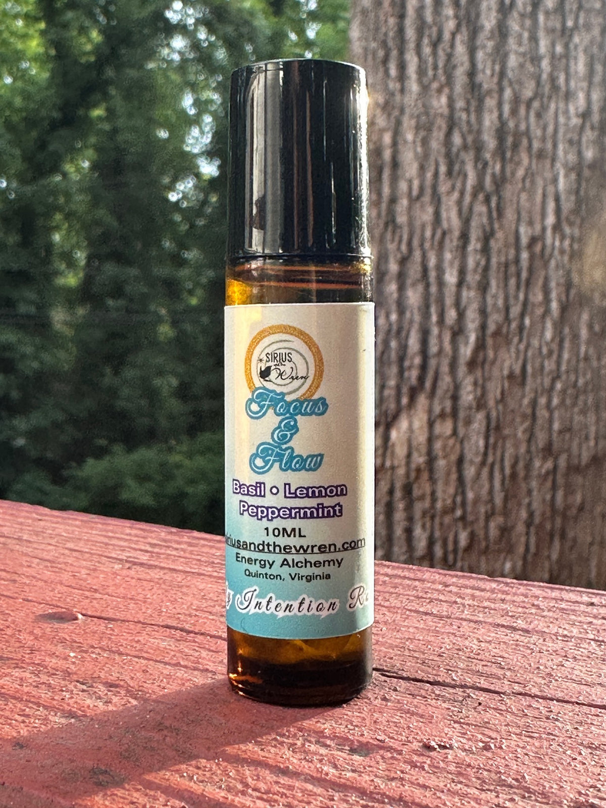 Focus + Flow Intention Roller on a wooden surface outdoors